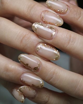 Cream short nails with gold foil bits
